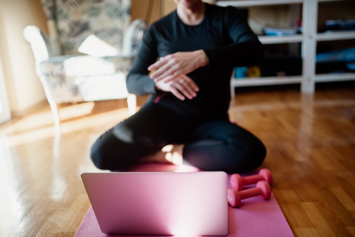person stretching on yoga mat for stress relief