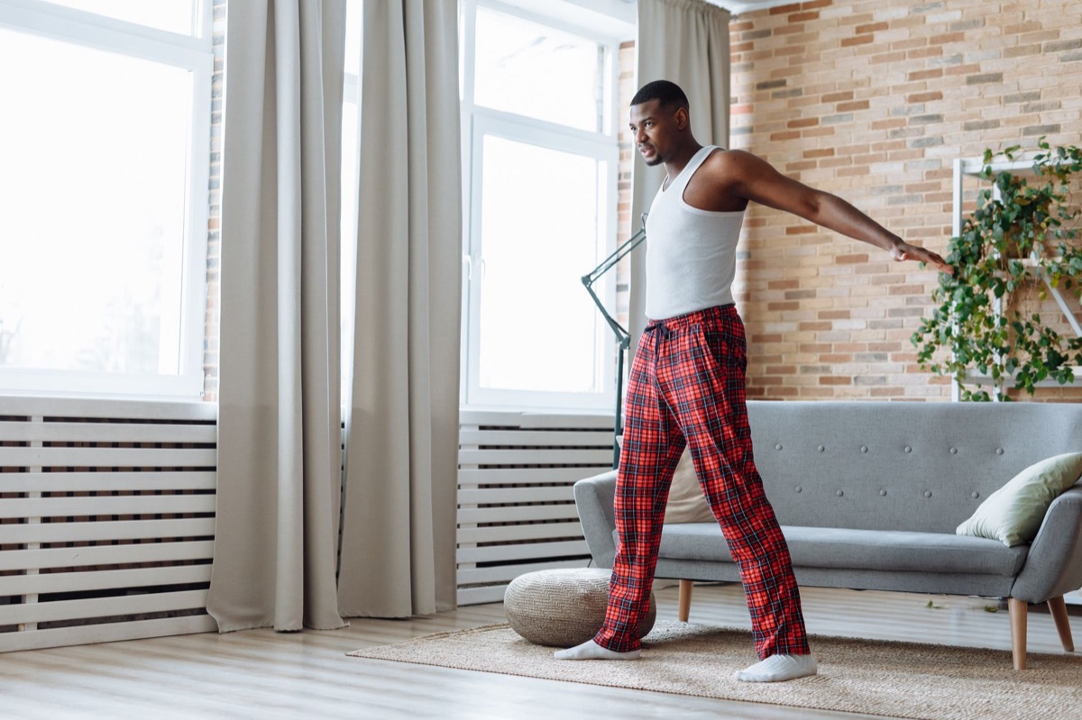 person doing gentle stretching in a living room